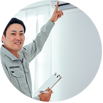 エアコンをチェックする作業員の写真