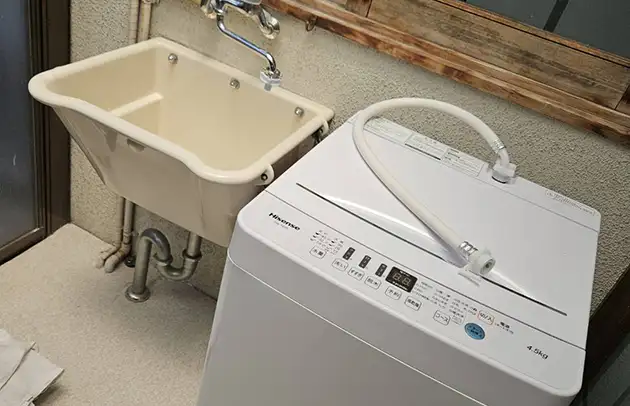 米原市柏原の洗濯機給水ホース根元の水漏れ施工事例写真